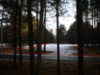 działka - widok z przodu od wąskiej asfaltowej drogi publicznej